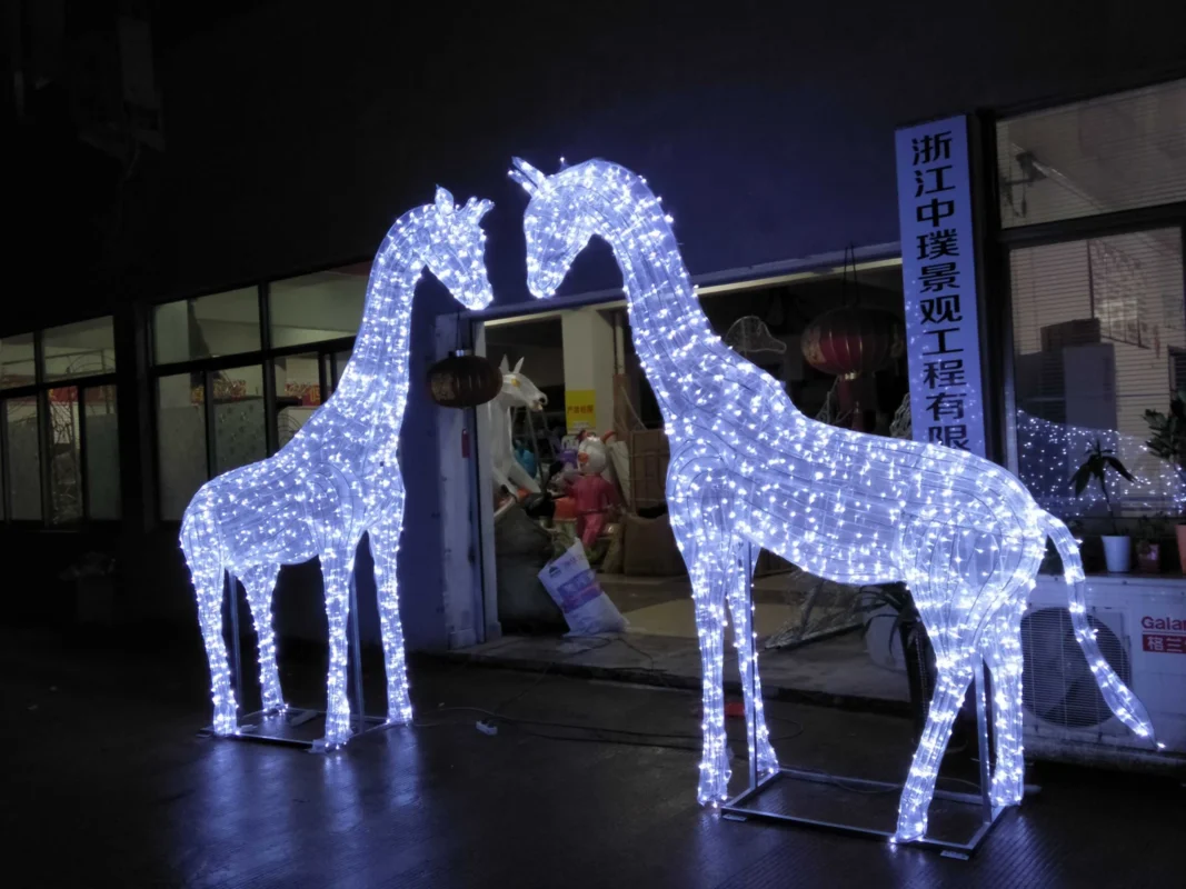 Two illuminated deer-shaped decorative light forms.