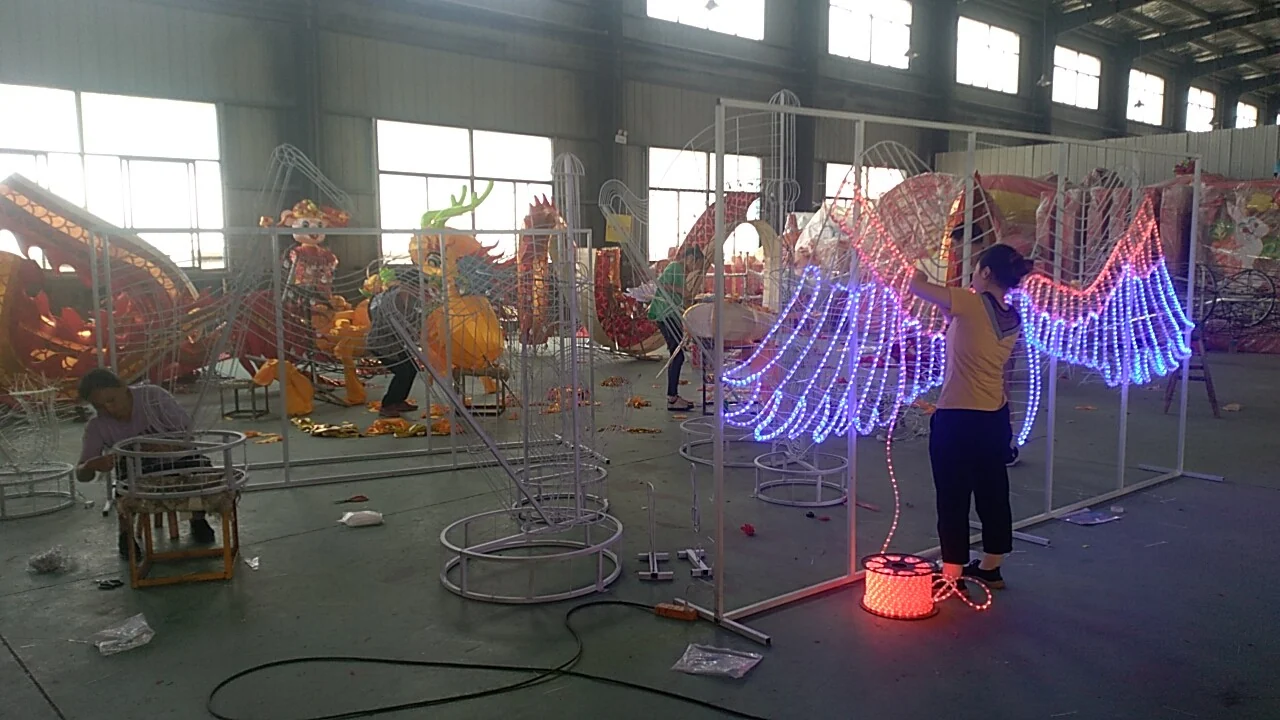 Decorative light forms and frames shown in the workshop.