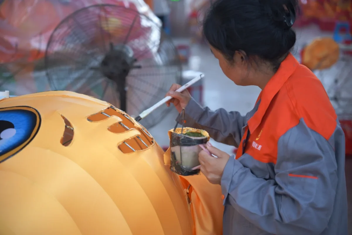 A maker working on the surface of a lantern character.