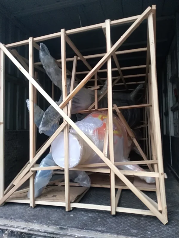 A decorative component supported within a timber transport frame.